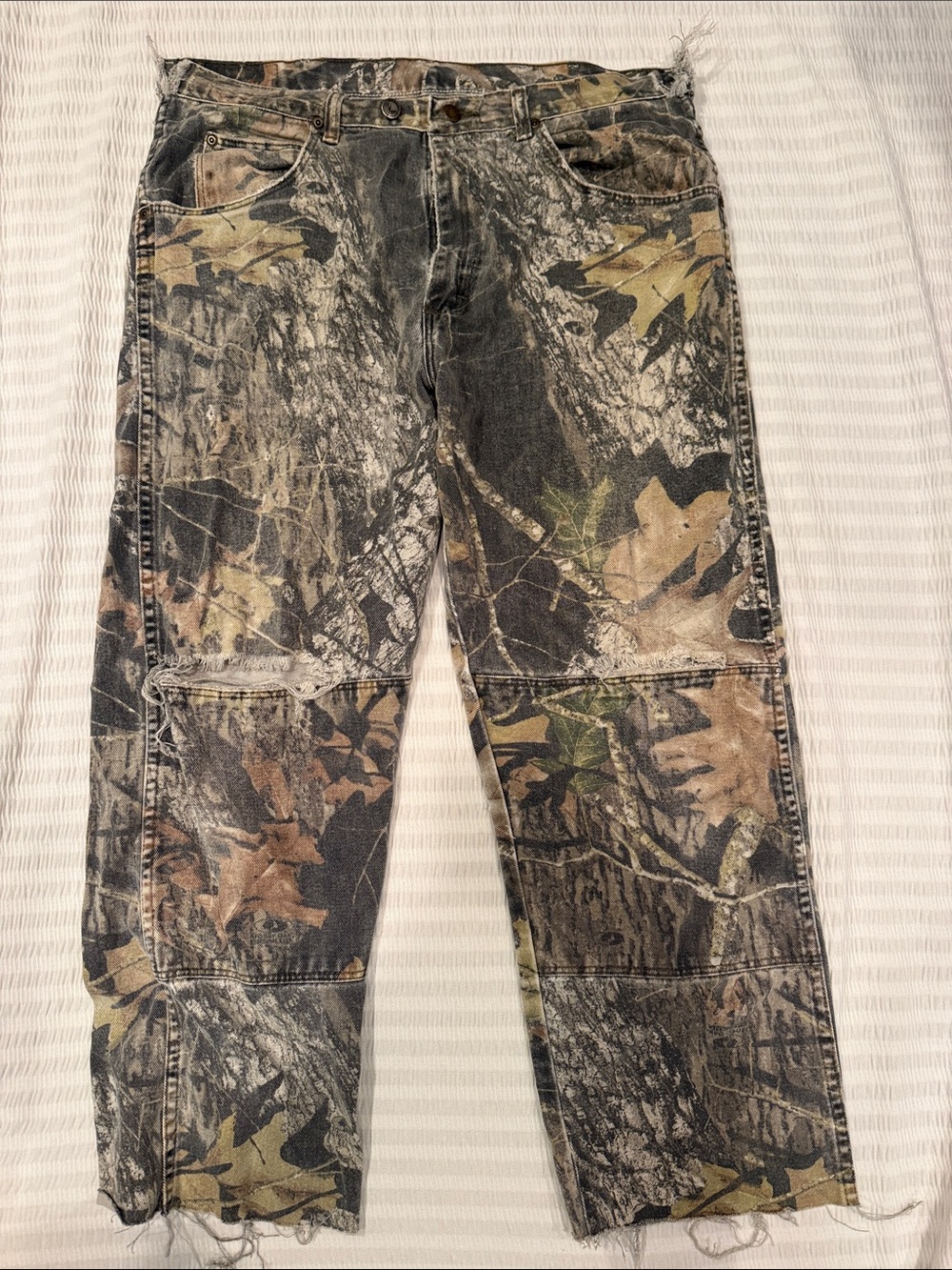 Distressed wranger Camo jeans. See photos for sizes